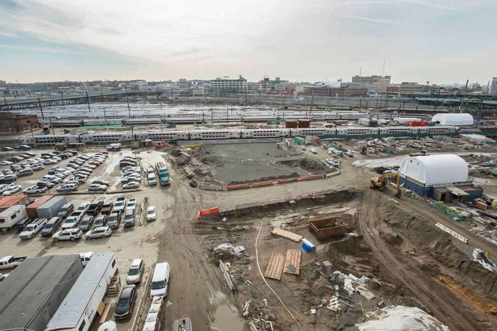 Aerial view of construction next to railroad yard